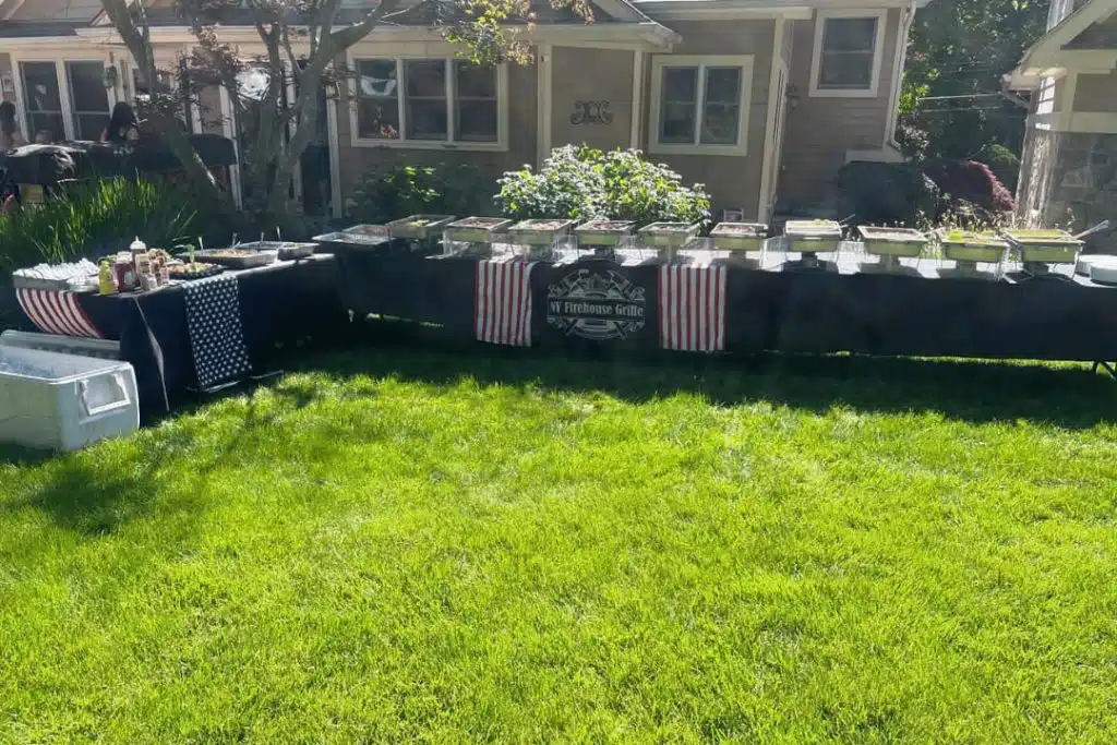 catering takeout buffet setup with trays of food for outdoor event